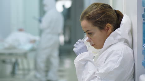 Portrait-of-Tired-Female-Doctor-in-Protective-Suit-at-Work